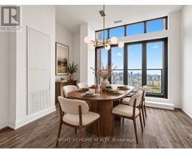 A dining room with a table set for two and a view of the city.