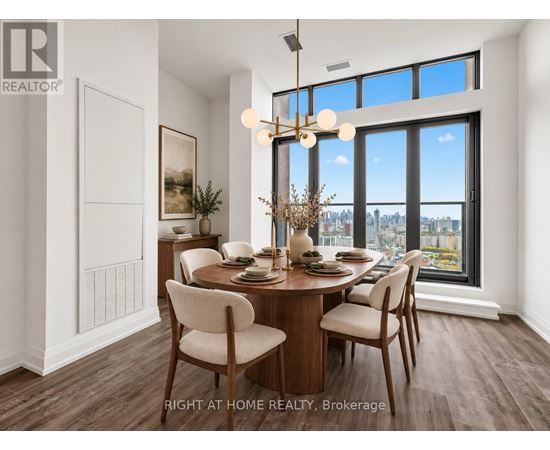 A dining room with a table set for two and a view of the city.