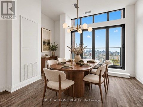 A dining room with a table set for two and a view of the city.