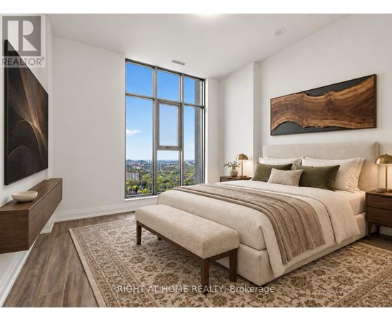 A bedroom with a large bed and a view of the city.