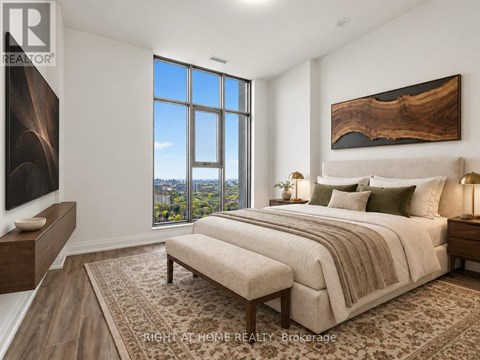 A bedroom with a large bed and a view of the city.
