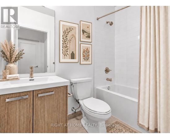 A bathroom with a toilet, sink, and a shower.