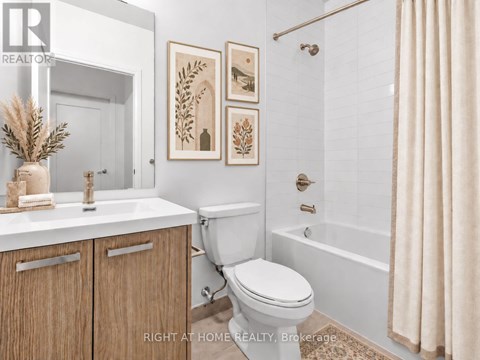 A bathroom with a toilet, sink, and a shower.