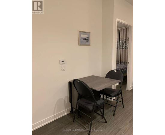 A dining room with a table and chairs.