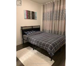 A bedroom with a bed and a painting on the wall.