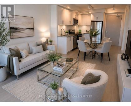 A modern living room with a glass coffee table and a white sofa.