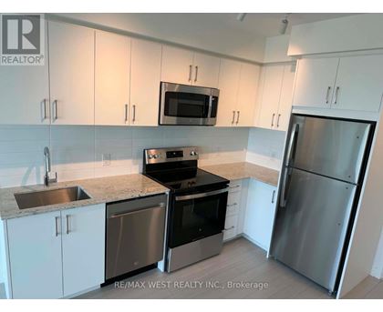 A kitchen with white cabinets and stainless steel appliances.