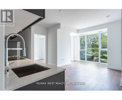 A modern kitchen with a sink and a stainless steel faucet.
