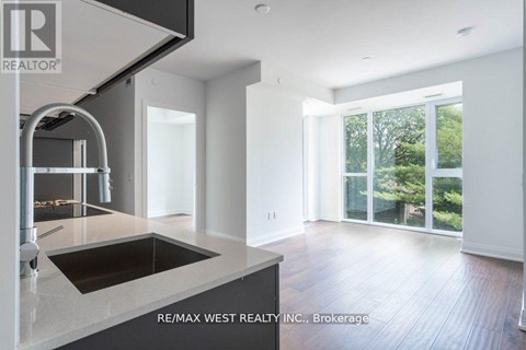 A modern kitchen with a sink and a stainless steel faucet.