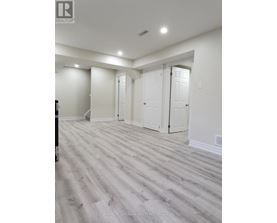 A room with white walls and a wooden floor.