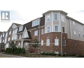 A large brick building with a sign that says REALTOR in the corner.