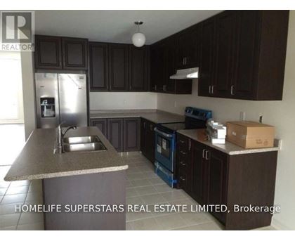 A kitchen with dark brown cabinets and a granite countertop.