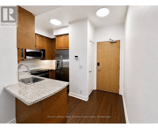 A kitchen with wooden cabinets and a sink.