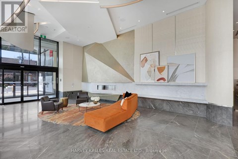 A modern living room with a large orange sofa and a coffee table.