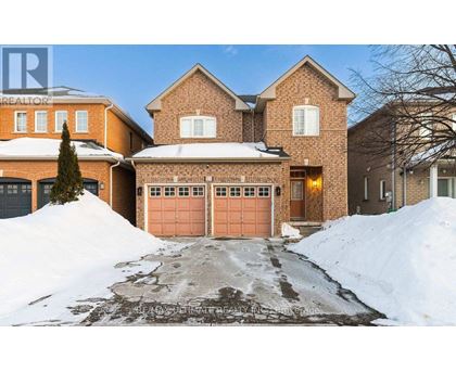 A house with a snow-covered driveway in front.