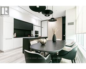 A modern dining room with a table set for four.