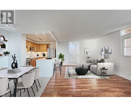 A modern living room with a dining table and chairs.