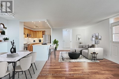 A modern living room with a dining table and chairs.