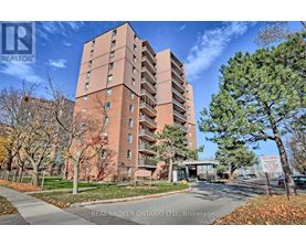 A tall brick apartment building with a sign that says "REAL BROKER ONTARIO LTD, Brokerage" in front of it.