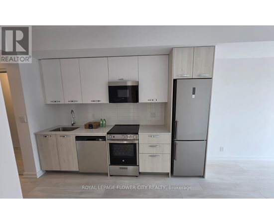 A kitchen with white cabinets and stainless steel appliances.