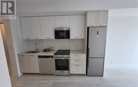 A kitchen with white cabinets and stainless steel appliances.
