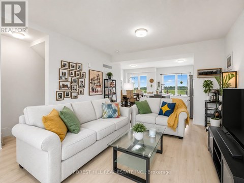 A living room with a white couch and a glass coffee table.