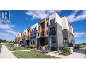 A modern apartment complex with a clear blue sky in the background.