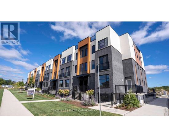 A modern apartment complex with a clear blue sky in the background.