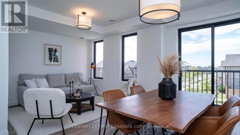 A dining room with a wooden table and chairs.