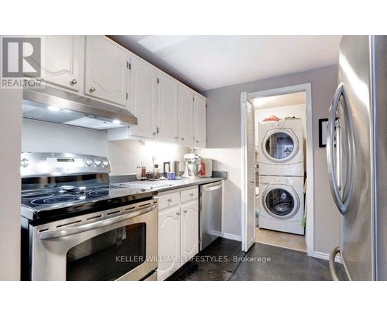 A modern kitchen with white cabinets and stainless steel appliances.