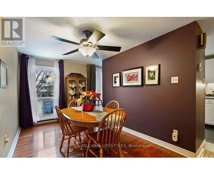 A dining room with a table set for four.