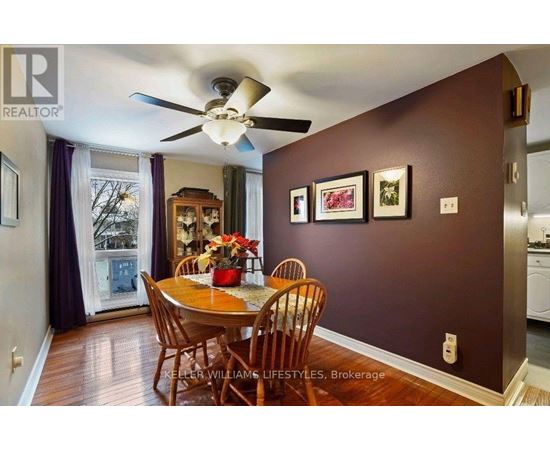 A dining room with a table set for four.