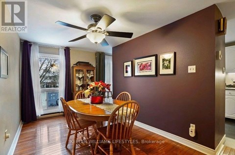 A dining room with a table set for four.