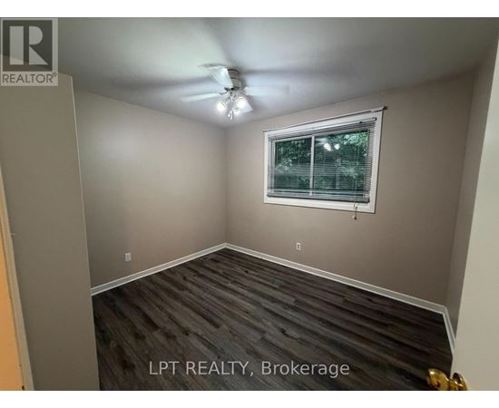 A room with a window and a ceiling fan.