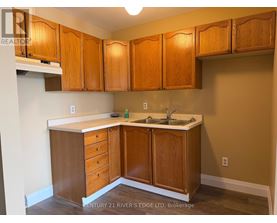 A kitchen with wooden cabinets and a white countertop.