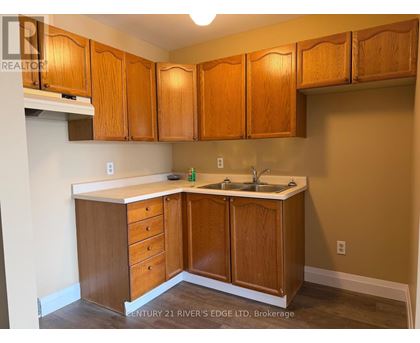 A kitchen with wooden cabinets and a white countertop.