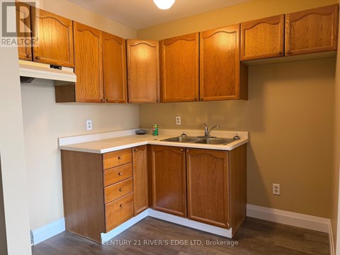 A kitchen with wooden cabinets and a white countertop.