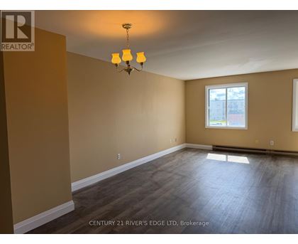 A room with a chandelier and a window.