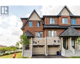A large brick house with a garage and a sign that says Century Paramount Realty.