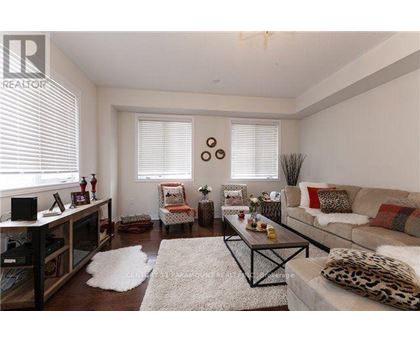 A living room with a leopard print couch and a white rug.