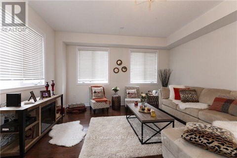 A living room with a leopard print couch and a white rug.