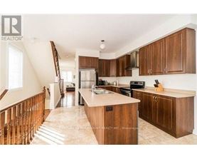 A kitchen with wooden cabinets and a marble countertop.