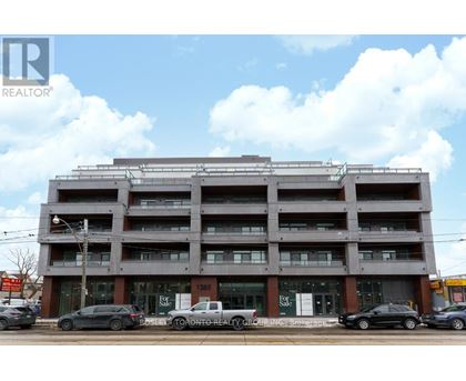 A multi-story building with a parking garage in front.