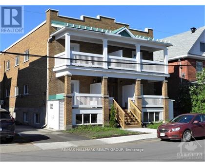 A two-story building with a balcony is being sold by RE/MAX Hallmark Realty Group.