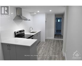 A modern kitchen with a stove top oven and a sink.