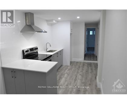 A modern kitchen with a stove top oven and a sink.