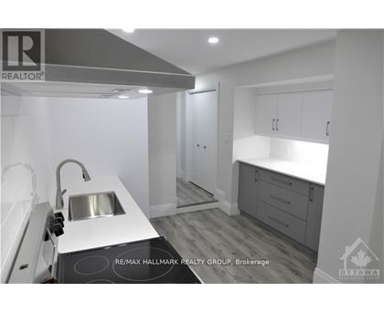 A modern kitchen with a sink and cabinets.