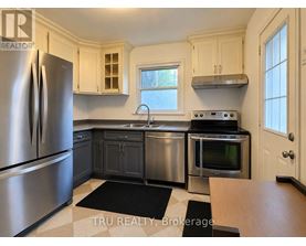 A kitchen with a stainless steel refrigerator and oven.