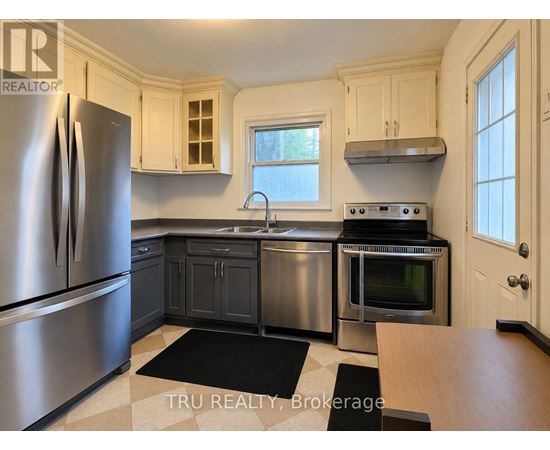 A kitchen with a stainless steel refrigerator and oven.