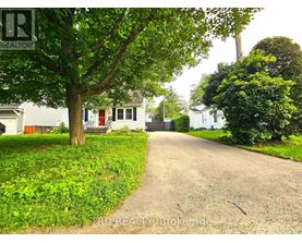 A residential area with houses and a tree-lined street.